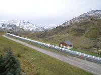 a long train traveling down a road in the mountains at Appartement Les Menuires, 2 pièces, 4 personnes - FR-1-452-253 in Les Menuires