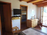 a bedroom with a television and a dresser with a bed at Appartement Crest-Voland, 3 pièces, 5 personnes - FR-1-595-65 in Crest-Voland