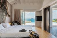 a bedroom with a bed and a view of the ocean at Infiniti Entire Luxury Villa Breath Taking View in St Barth in Pointe Milou