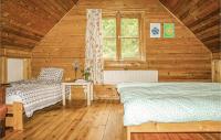 Posteľ alebo postele v izbe v ubytovaní Four-Bedroom Holiday Home In Milakowo