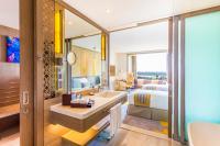 a bathroom with a bed and a sink in a room at Crowne Plaza Vientiane by IHG in Vientiane