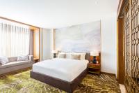 a hotel room with a bed and a couch at Crowne Plaza Vientiane by IHG in Vientiane