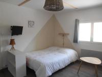 a bedroom with a bed and a tv on the wall at Entre Saint-Tropez et les gorges du Verdon. in Lorgues