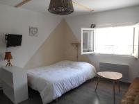 a bedroom with a bed and a table and a window at Entre Saint-Tropez et les gorges du Verdon. in Lorgues