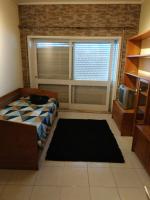 Postel nebo postele na pokoji v ubytování Bonfim Small House