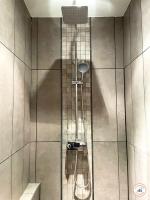 a shower with a shower head in a bathroom at l&#39;Orient-Express - Jacuzzi SPA - Parking - Loft in Le Havre