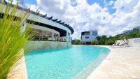 a swimming pool in front of a building at Amar'e Aparthotel & Spa in Las Terrenas
