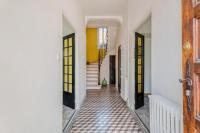 a hallway with white walls and a tile floor at L&#39;Ardeche en Provence avec jardin ombragé in Pont-Saint-Esprit