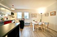 a kitchen and dining room with a table and chairs at Le duplex du quai mer in Concarneau