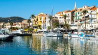 a group of boats docked in a harbor with buildings at Les Rivages de Stagnola Appartement T3 vue mer et montagne plage 200m climatisé in Pietrosella