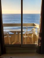 a view of the ocean from a balcony with a table and chairs at Biarritz centre balcon vue mer, piscine, plage in Biarritz
