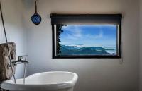 a bathroom with a white sink and a window at Sunny Room in Jiufen