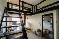 a room with two bunk beds and a ladder at Sunny Room in Jiufen