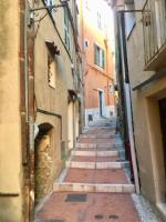 an alley with a bunch of stairs in a building at Duplex vue mer 50m de la plage des Sablettes in Menton