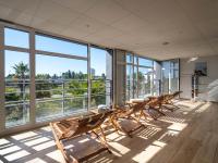 a row of benches in a room with windows at Westotel Le Pouliguen in Le Pouliguen