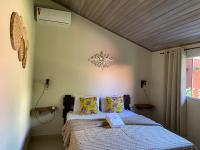 a bedroom with a bed with a wooden ceiling at Chico de Sá Pousada in Pirenópolis