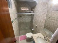 a bathroom with a shower and a toilet and a sink at Chico de Sá Pousada in Pirenópolis