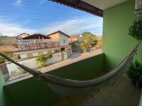 a hammock in a room with a view of a building at Chico de Sá Pousada in Pirenópolis