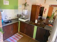 a kitchen with a sink and a counter top at Chico de Sá Pousada in Pirenópolis