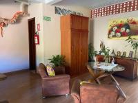 a living room with a table and chairs at Chico de Sá Pousada in Pirenópolis