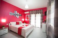 a red bedroom with a bed and a red wall at B&amp;B Pepito in Cefalù