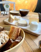 a plate of bread and cheese on a table at Maison Alfred et Agatha in Pleudihen-sur-Rance