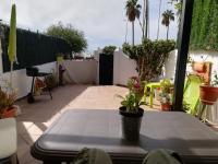 a patio with a table with potted plants on it at Casa Las Toro Playa in Chilches