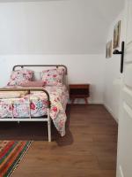 a bedroom with a bed and a wooden floor at Pavillon d&#39;Aÿ cottage Champagne - Label Green Key in Ay