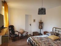 a bedroom with a bed and a table and a chair at Pavillon d&#39;Aÿ cottage Champagne - Label Green Key in Ay