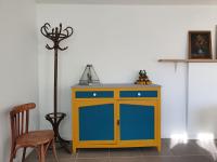a yellow and blue cabinet in a room with a chair at Pavillon d&#39;Aÿ cottage Champagne - Label Green Key in Ay