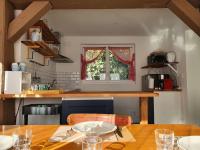 a kitchen with a wooden table and a window at Pavillon d&#39;Aÿ cottage Champagne - Label Green Key in Ay