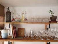 a shelf with wine glasses and books on it at Pavillon d&#39;Aÿ cottage Champagne - Label Green Key in Ay