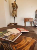 a wooden table with books on top of it at Pavillon d&#39;Aÿ cottage Champagne - Label Green Key in Ay