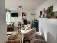 a living room with two couches and a tv at Pavillon d&#39;Aÿ cottage Champagne - Label Green Key in Ay