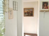 a hallway with a painting on the wall and a picture at Pavillon d&#39;Aÿ cottage Champagne - Label Green Key in Ay