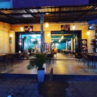 a restaurant with tables and chairs at night at Samui Green Hotel in Chaweng