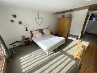 a bedroom with a bed and a wooden cabinet at Le Vancouver in La Plagne