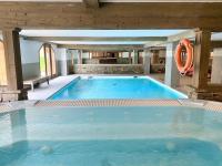 a large blue swimming pool with an orange lifesaver at Le Vancouver in La Plagne