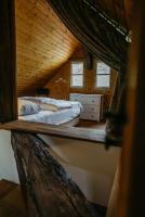 a bedroom with a bed in a wooden cabin at Kellerstöckl Berg 106 in Strem