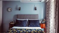 a bedroom with blue walls and a bed with blue pillows at Maison Saintonge in Paris