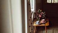 a table with two cups and a vase of flowers at Maison Saintonge in Paris