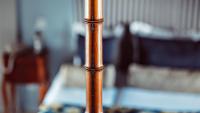 a wooden pole in a room with a bed at Maison Saintonge in Paris