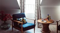 a room with a chair and a table and a window at Maison Saintonge in Paris