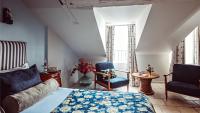 a bedroom with a bed and two chairs and a table at Maison Saintonge in Paris