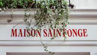 a sign on the side of a building with plants at Maison Saintonge in Paris