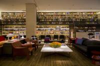 a lobby with a library with couches and a table at Eslite Hotel in Taipei