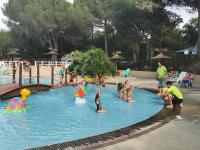 a group of people playing in a pool at a water park at Mobile home 5-pers Camping Leï Suves-Côtes d&#39;Azur-including airco in Roquebrune-sur-Argens