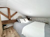 a bedroom with a large bed in a attic at Le Cocon - Coeur de ville in La Rochelle