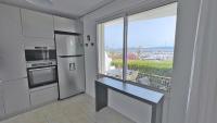 a kitchen with a counter and a large window at Miremer in Sainte-Maxime