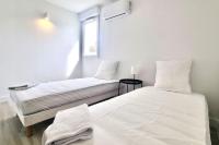 Łóżko lub łóżka w pokoju w obiekcie Résidence Anthérieu - Appartements neufs tout confort